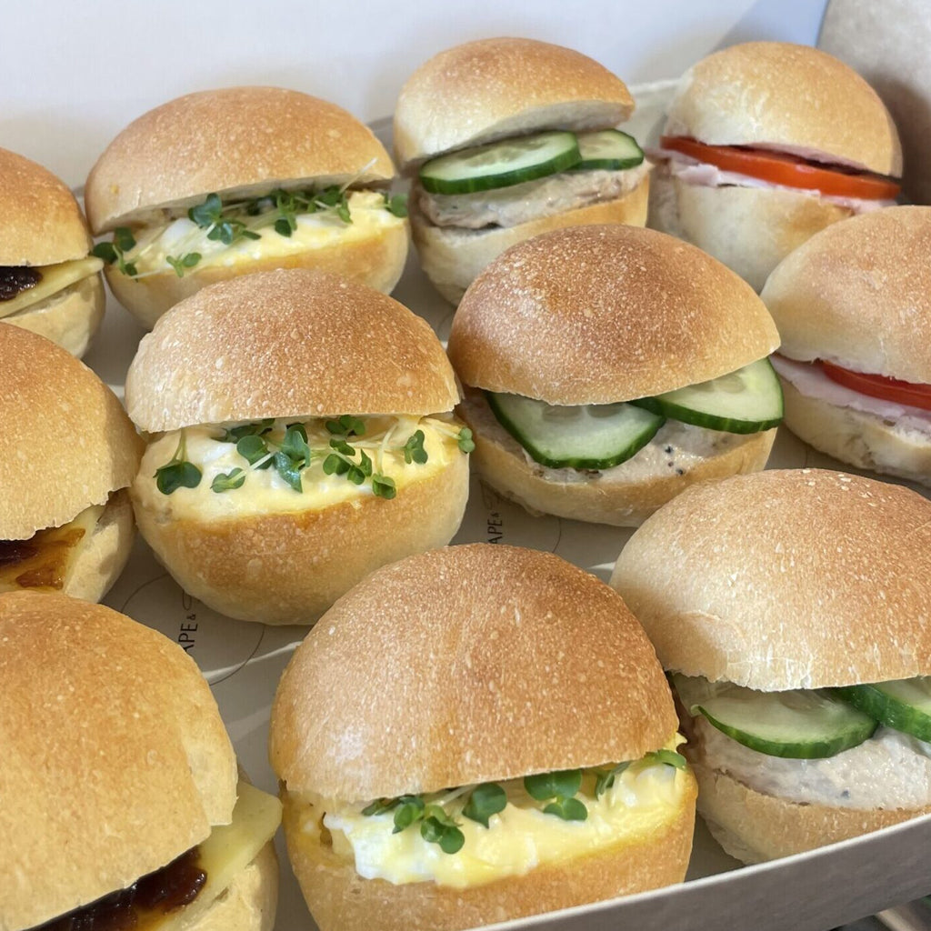 Assorted mini sandwich buns with various fillings on a tray