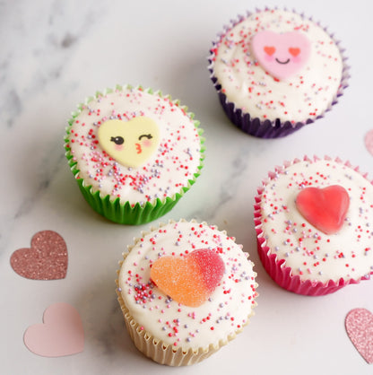 4 flat iced cupcakes on a marble surface