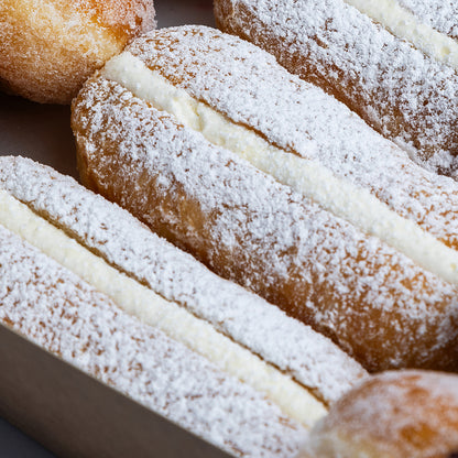 Close-up of powdered sugar-dusted doughnuts with a soft focus background