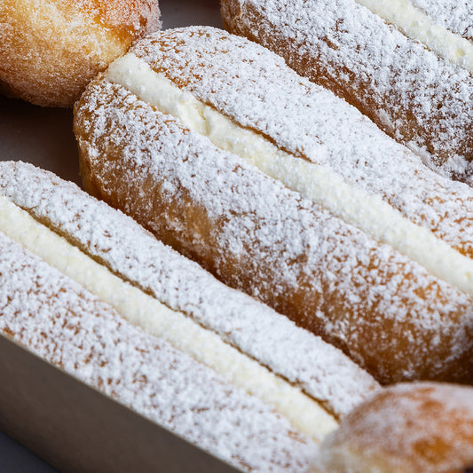 Close-up of powdered sugar-dusted doughnuts with a soft focus background