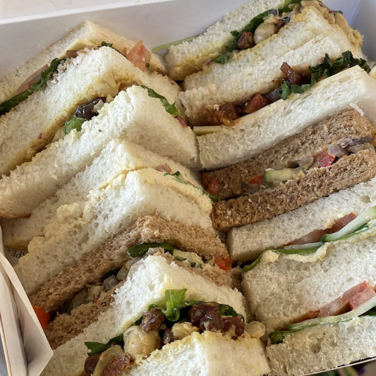 Assorted vegan triangles of sandwiches in a box