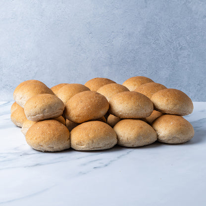 Pile of bread rolls on a marble surface with a light blue background