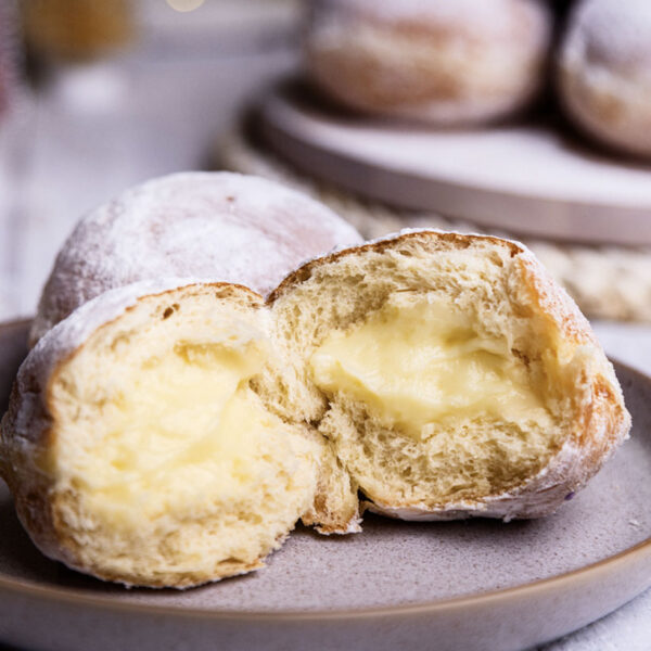 Inside look at a custard snowball doughnut showcasing the custard filling